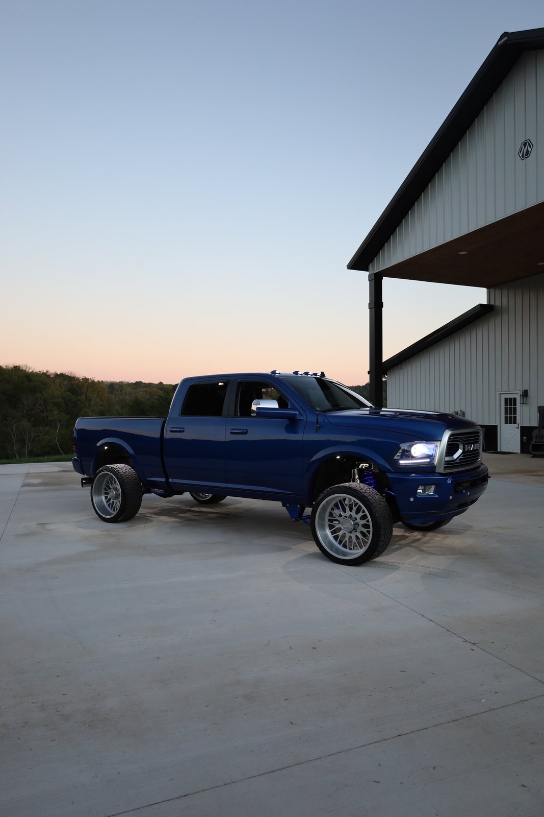 Blue Ram side profile parked at sunset
